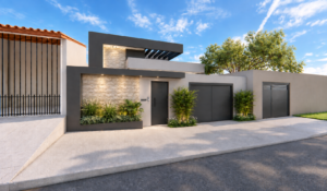 Fachada de residência contemporânea em Goiânia com volumes retos, revestimento em pedra, portões escuros e paisagismo junto à entrada.